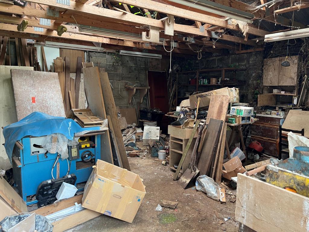 Lot: 128 - THREE-BEDROOM COTTAGE FOR IMPROVEMENT IN POPULAR VILLAGE LOCATION - An internal view of the workshop